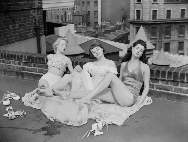 Chorus girls from the show 'Sauce Tartare' at the Cambridge Theatre in London, relax on the roof of the theatre, 28th June 1949. From left to right, they are Aud Johanssen of Norway, Audrey Hepburn (1929 - 1993) and Enid Smeedon. (Photo by Ron Case/Keystone/Hulton Archive/Getty Images)