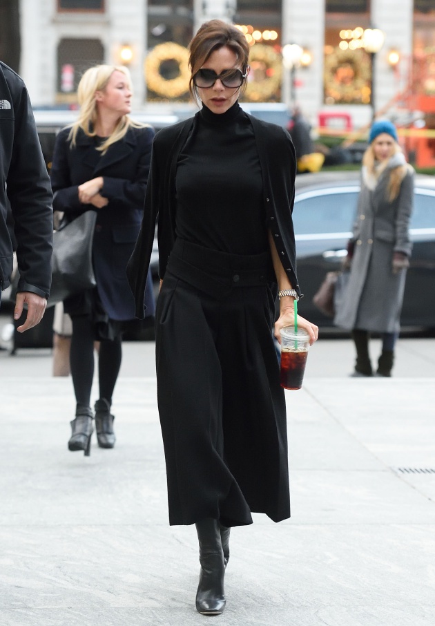 Victoria Beckham steps over some trash while carrying her Starbucks drink NYC