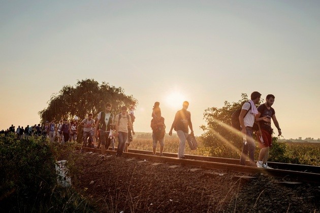 Horgos, Serbia September 13, 2015. Refugees and migrants walking towards a checkpoint along the railway tracks connecting Horgos and Szeged near Roszke, in the vicinity of the border between Serbia and Hungary.