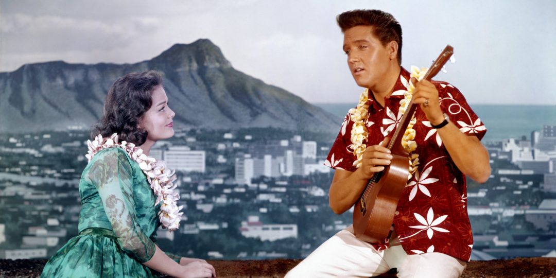 LOS ANGELES - APRIL 1964: Rock and roll singer and actor Elvis Presley in a movie still with a woman on the set of 'Blue Hawaii' at Paramount Pictures in April of 1961 in Los Angeles, California. (Photo by Michael Ochs Archives/Getty Images)