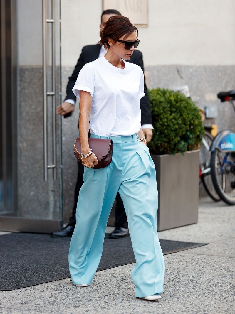 Victoria Beckham out and about in a white shirt and baby blue trousers in New York