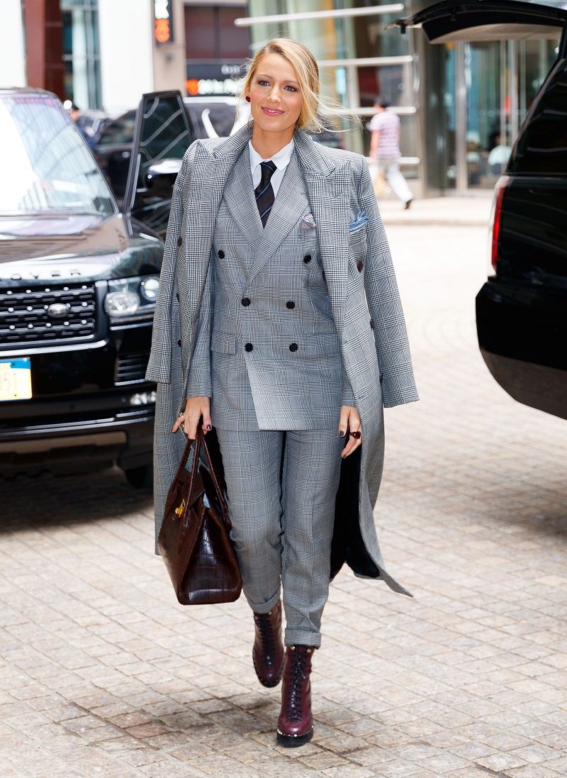 Blake Lively is all smiles in a double-breasted suit when coming out of her hotel in New York