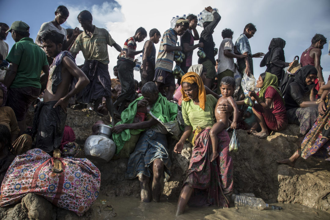 On 16 October 2017, Rohingya refugees including women and children cross into Bangladesh at Palong Khali in Cox’s Bazar district. Between 10000 and 15000 newly arrived Rohingya refugees fleeing Myanmar crossed into Bangladesh, and are stuck in Palong Khali in Cox’s Bazar district approximately 2 kms from the border with Myanmar. Thousands of people are queuing up on pedestrian road in the midst of paddy fields and waterbodies in a queue approximately 1 km long. Thousands among them are children. People making long journeys by walking and crossing the river are in desperate condition. They are exhausted, dehydrated, hungry and are urgently in need of water. People are getting sick due to dehydration, while lots are also traumatized. Some children have been separated from their families during their journey. UNICEF has mobilized resources for the newly arrived Rohingyas. Two water trucks carrying 6000 litres of water and 2000 jerrycans are on the site for distribution. Distribution started this morning by boat to the refugees located near the border area. Another 20,000 bottles of water each containing 1.5 litre are on the way from Chittagong. UNICEF is prepositioning two mobile child friendly spaces at the site for assessment and family tracing and reunification. UNICEF also plans to mobilize immunization and nutrition screening for this new influx. Two UNICEF nutrition and health teams are currently on the ground. As of 15 October 2017, at least 795,000 Rohingyas are estimated to be sheltering in Bangladesh, having fled violence and persecution in Myanmar. Violence which began on 25 August has triggered a massive and swift refugee influx across the border - an estimated 582,000 people have arrived. These refugees have joined some 213,000 people who were already in Bangladesh following earlier waves of displacement. The Rohingya population in Cox’s Bazar is highly vulnerable, many having experienced severe trauma, and are now living in extremely difficul