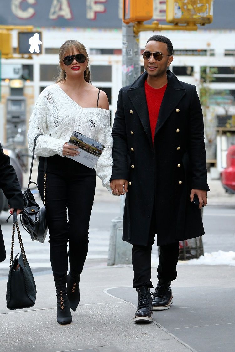 Model Chrissy Teigen and singer John Legend hold hands as they walk to their old apartment in New York City, New York.
