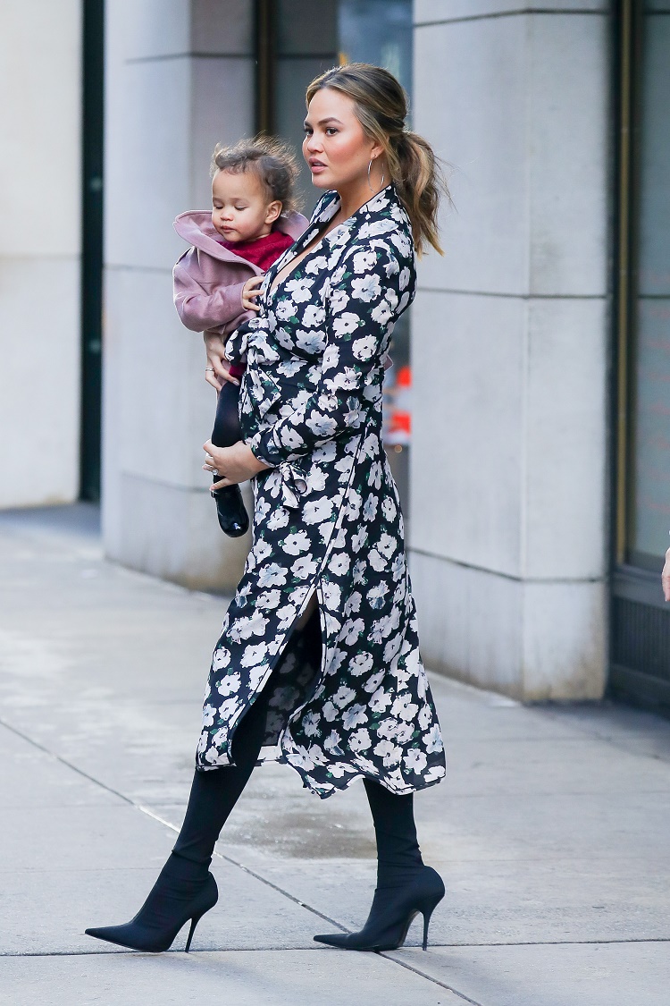 Chrissy Teigen was spotted carrying her daughter Luna while leaving Barney's New York on Madison Ave in New York City