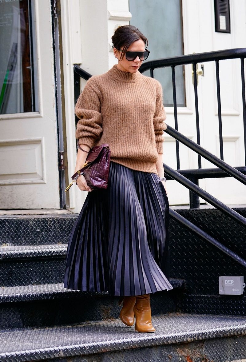 Victoria Beckham fixes her sleeve after shopping at a vintage clothing store 'What Goes Around Comes Around' in Soho, New York