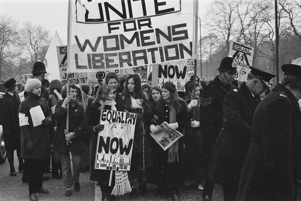 National Women's Liberation Movement, on an equal rights march from Speaker's Corner to No.10 Downing Street, to mark International Women's Day, London, 6th March 1971. One woman is carrying a placard reading 'Equal Pay Now'. On the right, a woman is holding a copy of the Trotskyist publication 'Red Mole'. (Photo by Daily Express/Hulton Archive/Getty Images)